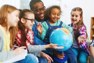 Studying the world Teacher with his pupils studying the world with the help of globe